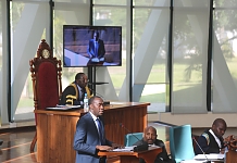 Hon Paul Musamali presents the Resolution  paying tribute to the Clerk and the Deputy  Clerk whose tenure of service at the Assembly (and the Community) ended last week