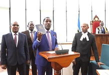 Hon Peter Munya, Cabinet Secretary for EAC and Northern Corridor Development, Kenya takes the Oath of Allegiance to the EAC administered by EALA Senior Clerk Assistant, Gasana Stephen Mugume  and before the Speaker (seated on the right). Accompanying Hon
