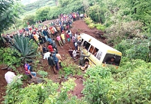 Residents gather at the scene of an accident that killed schoolchildren, teachers and a minibus driver at the Rhota village along the Arusha-Karatu highway in Tanzania's northern tourist region of Arusha, May 6, 2017.