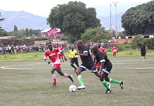 Hon Julius Maganda with ball goes past Allan Opiyo of the Parliament of Kenya as Hon Gideon Gatpan races alongside