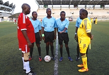EALA Captain, Kenneth Madete (left) and the Captain of the Bunge Sports Club, Tanzania, Hon Gibson Ole Meseyiek look on as the referee tosses a coin at the start of the match. EALA beat Parliament of Tanzania 6-0 in an entertaining match