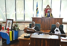 The Speaker, Rt Hon Daniel F. Kidega communicates to the Assembly at the start of the Special Sitting. In the foreground is Clerk, Kenneth Madete (left) and Senior Clerk Assistant, Stephen Mugume
