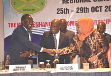 The Vice President of the United Republic of Tanzania, H.E. Samia Suluhu Hassan, shakes hands with EALA Speaker, Rt Hon Ngoga Karoli Martin as the Speaker of Parliament of Tanzania (centre) looks on